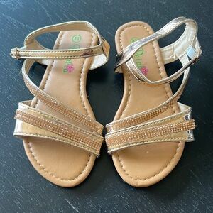 Little girl’s rose gold shiny sandals